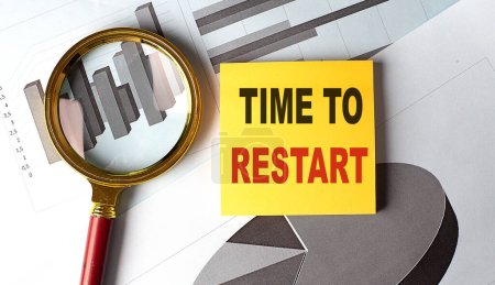 Photo for TIME TO RESTART text on sticky on chart, business - Royalty Free Image