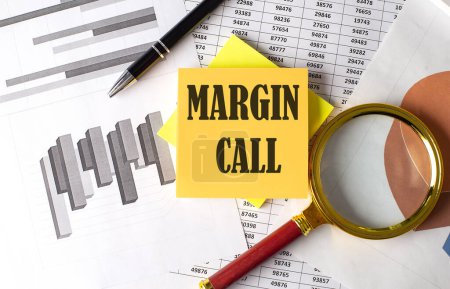 Photo for MARGIN CALL text on sticky on red notebook on chart background - Royalty Free Image