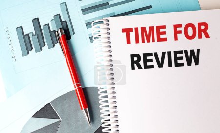 Photo for TIME TO REVIEW text on notebook with pen on a chart background - Royalty Free Image