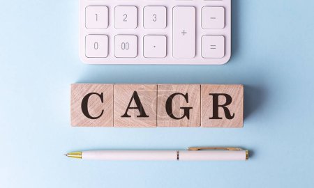 Photo for CAGR on a wooden cubes with pen and calculator, financial concept - Royalty Free Image
