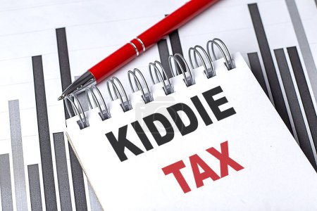 KIDDIE TAX text written on a notebook with pen on chart