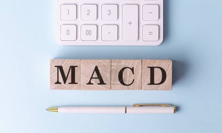 Photo for MACD on a wooden cubes with pen and calculator, financial concept - Royalty Free Image