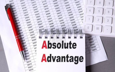 Photo for ABSOLUTE ADVANTAGE text on a notebook with pen, calculator and chart on grey background - Royalty Free Image
