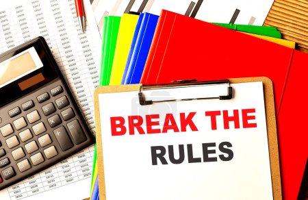 BREAK THE RULES text written on a paper clipboard with chart and calculator