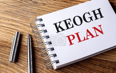 KEOGH PLAN text on a notebook with pen on wooden background