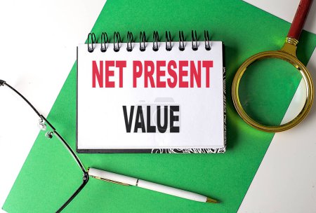 NET PRESENT VALUE text on a notebook on green paper