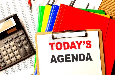 Photo for TODAY'S AGENDA text written on a paper clipboard with chart and calculator - Royalty Free Image