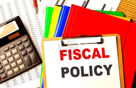 FISCAL POLICY text written on a paper clipboard with chart and calculator