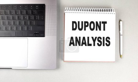 DUPONT ANALYSIS text on a notebook with laptop and pen