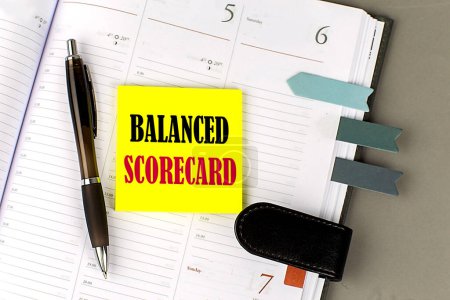 Photo for BALANCE SCORECARD text sticky on a dairy on gray background - Royalty Free Image