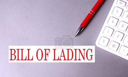 BILL OF LADING text on a gray background with pen and calculator.