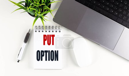 PUT OPTION text on a notebook with laptop, mouse and pen . 