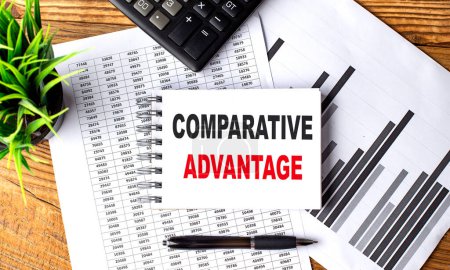 Photo for COMPARATIVE ADVANTAGE text on a notebook on chart with calculator and pen . - Royalty Free Image