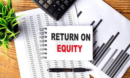 RETURN ON EQUITY text on a notebook on chart with calculator and pen . 