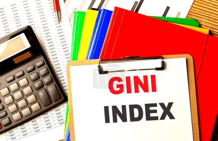 GINI INDEX text on a clipboard with calculator and color folder . 
