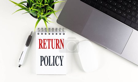 Photo for RETURN POLICY text on a notebook with laptop, mouse and pen . - Royalty Free Image