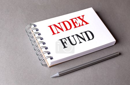 INDEX FUND text on a notebook on grey background 