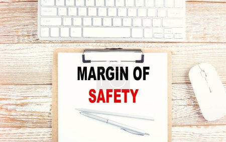 MARGIN OF SAFETY text on a clipboard with keyboard . 