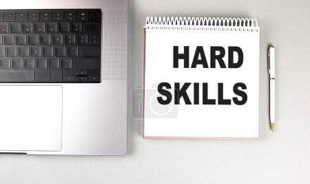 HARD SKILLS text on a notebook with laptop and pen . 