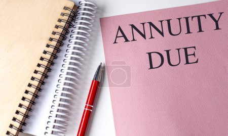 ANNUITY DUE text on a pink paper with notebooks . 