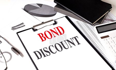 BOND DISCOUNT text on a clipboard on chart with notebook and calculator.