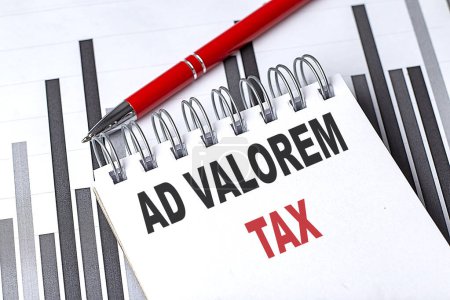 AD VALOREM TAX text on a notebook on chart with pen . 
