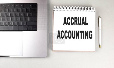 ACCRUAL ACCOUNTING text on a notebook with laptop and pen . 