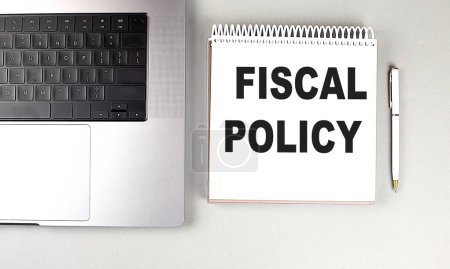 FISCAL POLICY text on a notebook with laptop and pen . 