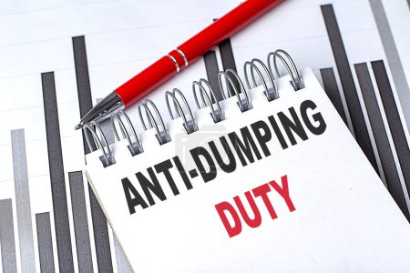 ANTI-DUMPING DUTY text on notebook on a chart with pen . 