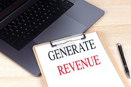 GENERATE REVENUE text on a clipboard on laptop 
