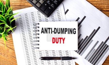 ANTI-DUMPING DUTY text on a notebook on chart with calculator and pen .