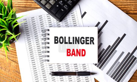 BOLLINGER BAND text on notebook on a chart with calculator and pen . 