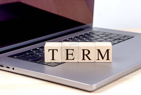 TERM word on a wooden block on a laptop , business concept. 