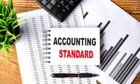 ACCOUNTING STANDARD text on notebook on a chart with calculator and pen . 