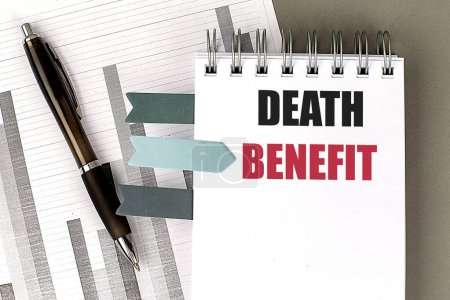 DEATH BENEFIT text on a notebook with chart on gray background 