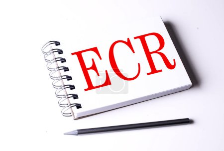 ECR word on a notebook on white background . 