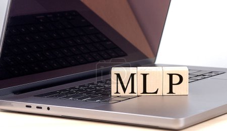 MLP Wort auf einem Holzklotz auf einem Laptop, Geschäftskonzept. 