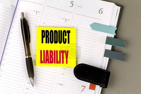 PRODUCT LIABILITY text sticky on dairy on a gray background. 