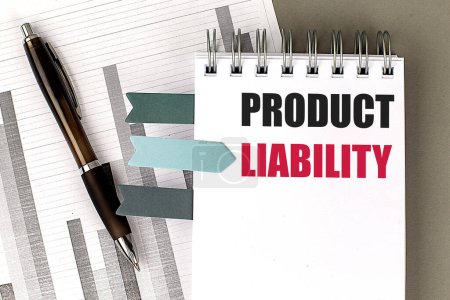 PRODUCT LIABILITY text on a notebook with chart on gray background 