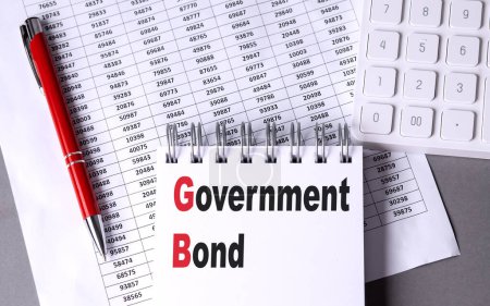 GOVERNMENT BOND text on a notebook with chart , pen and calculator. 