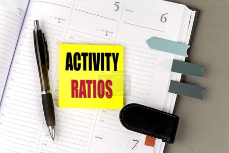 ACTIVITY RATIOS text sticky on a dairy on gray background. 