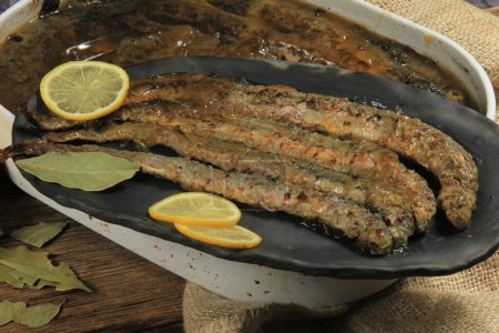 Fried whole lampreys on a plate, Fish delicacies, Latvian cuisine