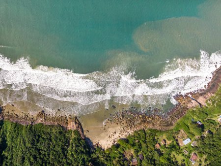 Photo for Coastline with beach, mountains and blue ocean with waves in Brazil. Aerial view of Saquinho beach. Florianopolis Santa Catarina. SC - Royalty Free Image