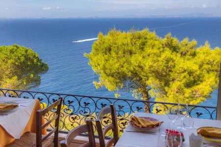 Restaurant table overlooking the sea on the Amalfi coast in Italy.