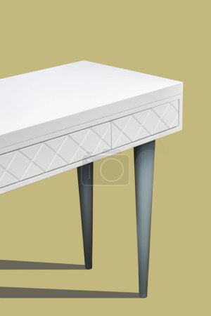 White dressing table with milled facades in shape of rhombs isolated on yellow background. Modern domestic furniture with stylish design for bedroom