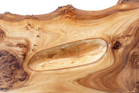 Live edge elm burl slab table top with central epoxy resin river on white background, combining natural wood with a synthetic material close view