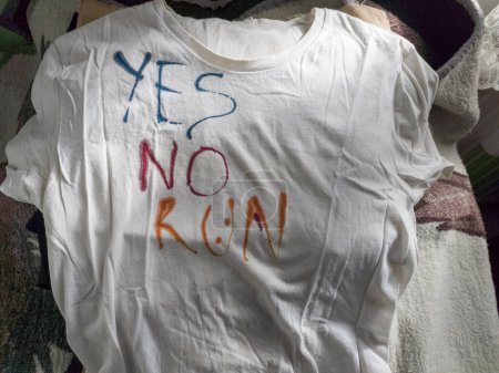 Photo for Writing Yes, No and Run on T-Shirt with Ink - Royalty Free Image