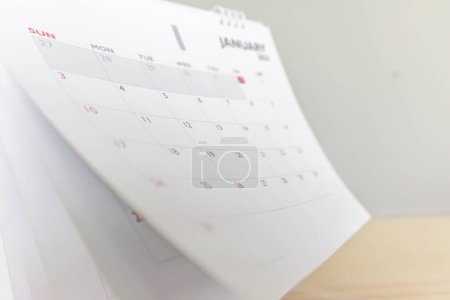 Photo for Calendar page flipping sheet on wood table background business schedule planning appointment meeting concept - Royalty Free Image