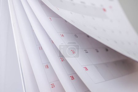 Calendar page flipping sheet close up blur background business schedule planning appointment meeting concept