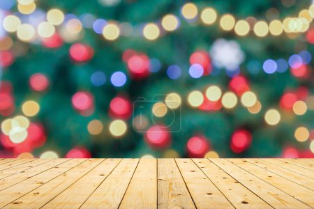 Empty wood table top with blur Christmas tree with bokeh light background Poster 625903320